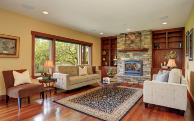 Beautifully refinished hardwood floors in a living room with built-in cabinets and a fireplace.